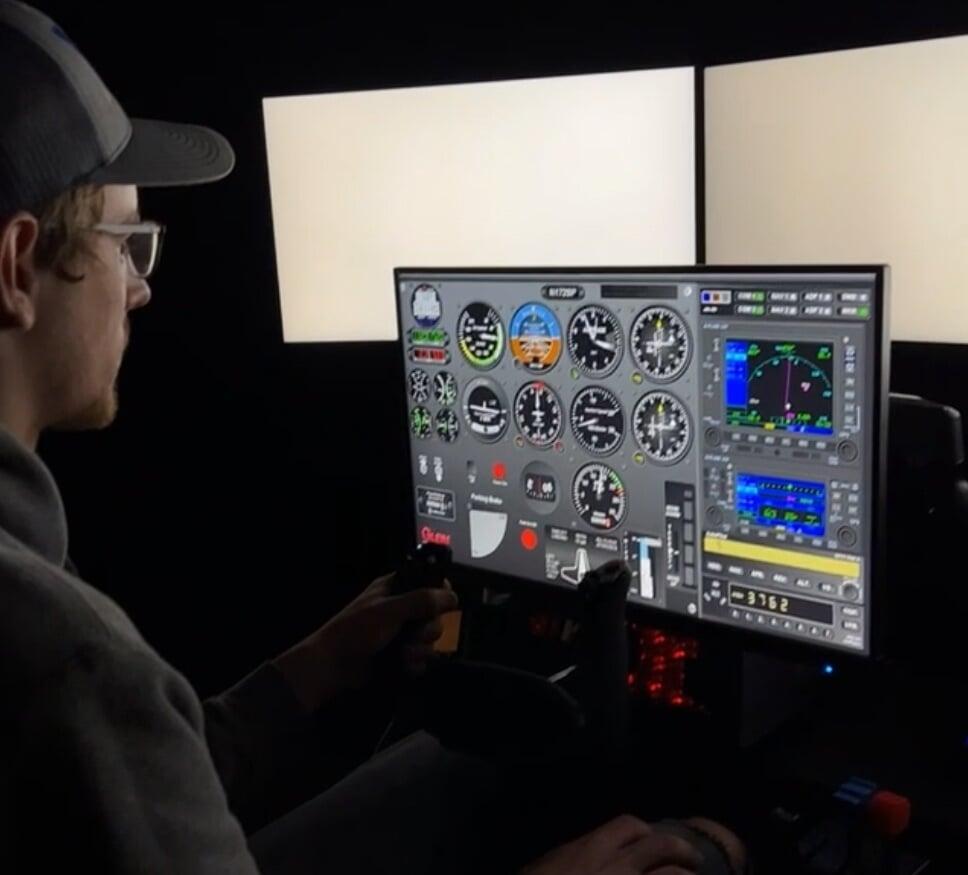 student pilot focuses intently on flying through clouds on Vx FAA approved flight simulator