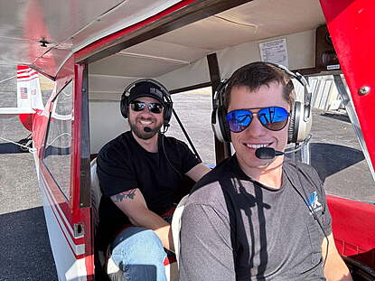 tailwheel instructor and student pilot with happy smiles in the bellanca champ